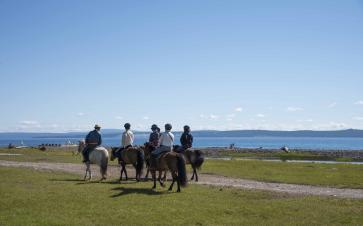 horse riding along the Lake Khuvsgul in Mongolia